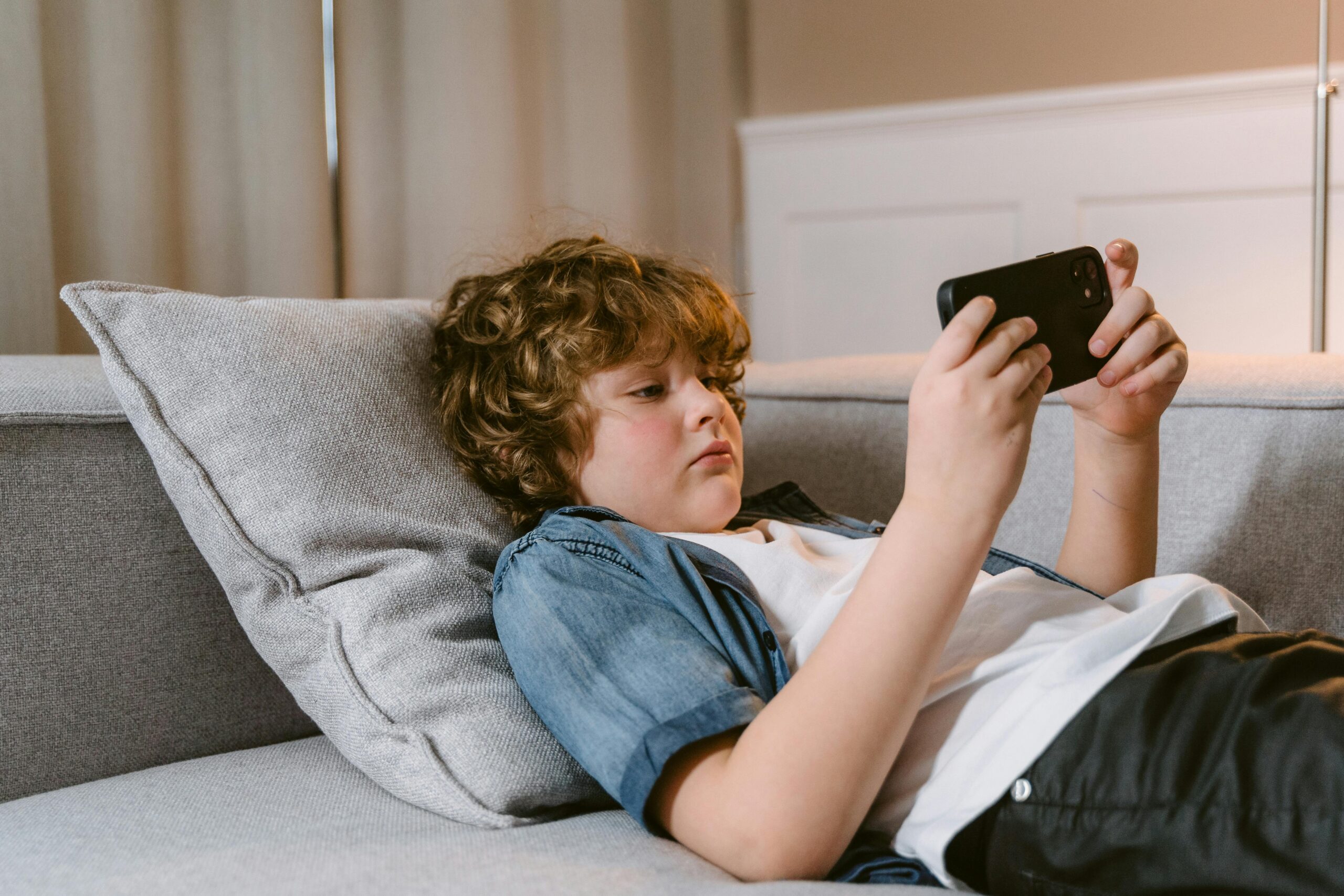 kid playing mobile game
